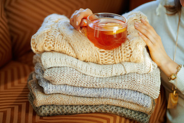 Closeup on elegant woman with sweaters and tea