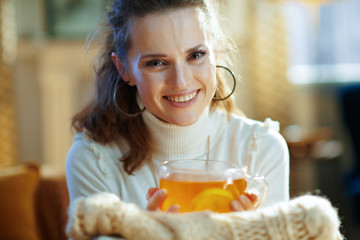 happy trendy woman with sweaters and tea