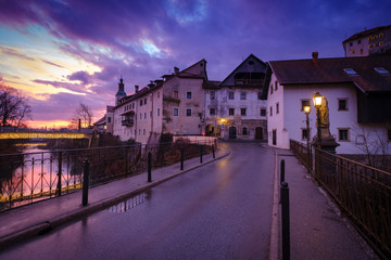 Colorful sunrise over stone bridge in Skofja Loka