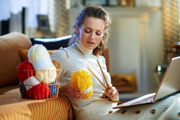 stylish woman with yarn learn how to knit