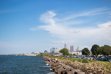 Beautiful summer landscape, which depicts the rocky shore of the lake, waves on the water and in...