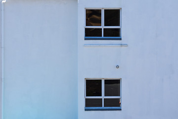 Fototapeta na wymiar Plain Building Wall With Gutter And Windows, Mossel Bay, South Africa