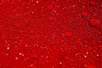 Water drops texture on red background