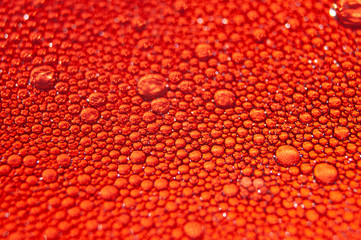 Water drops texture on red background