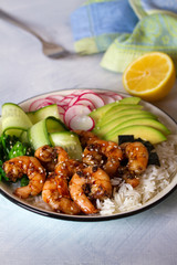 Honey soy shrimp rice bowl with spinach, radish cucumber, seaweed and avocado