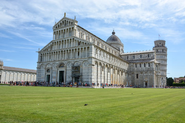 PISA, ITALY - August 14, 2019: The cathedral of Pisa near the leaning tower of Pisa with lots of tourists