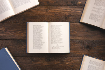 Open books with poems, isolated on wooden background. Flat lay, top view, copy space.