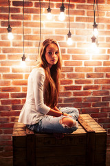 Fototapeta na wymiar young teenage girl posing cheerful in modern loft studio interior with many lights, lifestyle holiday people concept