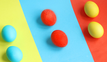 a pile of painted eggs in various colors, easter holiday concept