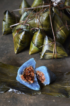 Delicious Blue Nyonya Dumpling On Concrete Floor. Zongzi Or Rice Dumpling Is Glutinous Rice With Sweet Or Savoury Fillings Wrapped In Bamboo Or Reed Leaves.