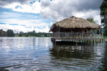 A cabin made of guadua and straw on the shore of the lake in Colombia