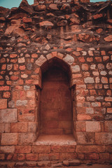 Fototapeta na wymiar Arch in ruins. New Delhi: Qutub (Qutb) Minar, the tallest free-standing stone tower in the world, and the tallest minaret in India, constructed with red sandstone and marble in 1199 AD. 