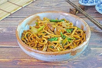 Fujian stir fried noodles or Hokkien Mee is a traditional noodle dish brought to Phuket by immigrants from the Fujian province of China, one of most popular food in Phuket Thailand. Selective focus. © Cheattha