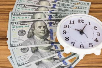 American hundred dollar bills and clock, business finance shopping concept. USA money.