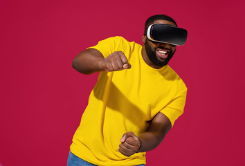 Man exploring new world of car races while wearing VR headset and gaming on red background