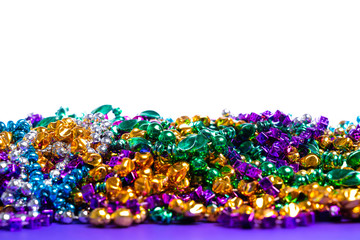 Mardi Gras beads on white background