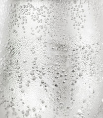 A glass of water with bubbles and waterdrops