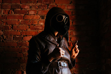 Terrible plague doctor on red brick background. Masked maniac with scalpel and scissors. Halloween...