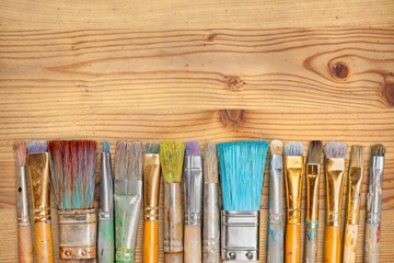 A row of artist paint brushes on desk