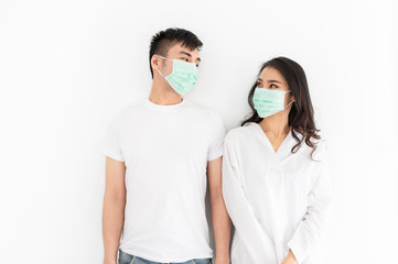 couple asian people wear surgical mask on white background, they want to pollution protection and virus protection, healthcare and infection control