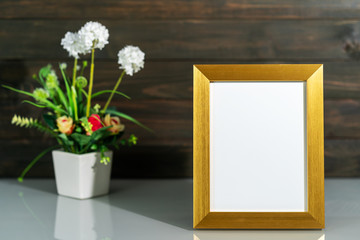 Picture mock up with golden frame and flower vase bouquet