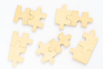 wooden jigsaw puzzle pieces on white background