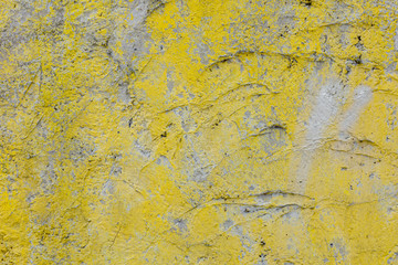 Texture of cement concrete wall with yellow paint.