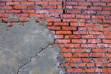 The brick wall is partially plastered, concrete texture