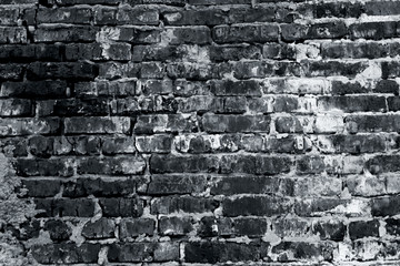 The brick wall is partially plastered, concrete texture