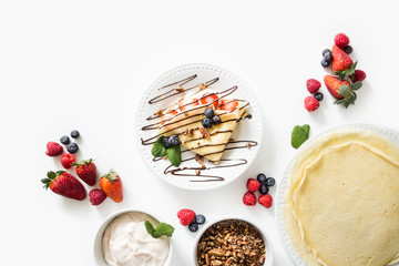 Crepes with berries and cream on White Background