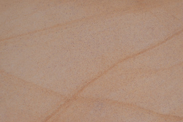 details of the brown sandstone textured background intersecting lines on delicate surface.