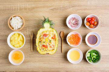 Thai food, pineapple fried rice and recipes for cooking on wooden background, vegetarian food	
