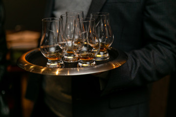 Glasses of whiskey on a tray.