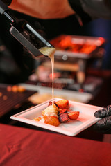 Raclette cheese over potatoes