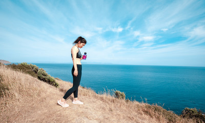 Sporty woman hiking on Makara beach, Wellington New Zealand