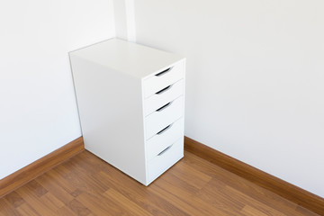 White modern cabinet on wood floor in white room