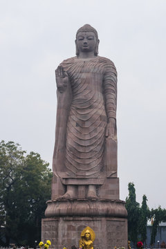 Large statue of standing Buddha in WAT THAI Temple, Sarnath city near Varanasi, India