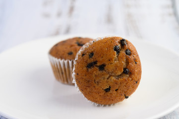 Banana cupcakes mixed with chocolate chip on a white plate.