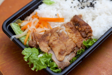 Rice and grilled chicken with herbs and seasoning with a top view.