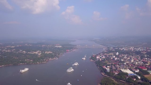 Drone shot flying over the sea and boats heading towards the land, Goa, India