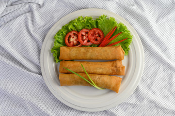 Egg roll or Fried Spring Rolls on the white plate Thai food. Top view.