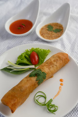Egg roll or Fried Spring Rolls on the white plate Thai food. Selective focus.