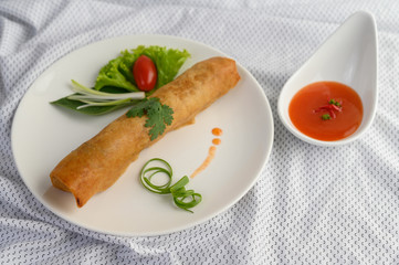 Egg roll or Fried Spring Rolls on the white plate Thai food. Selective focus.