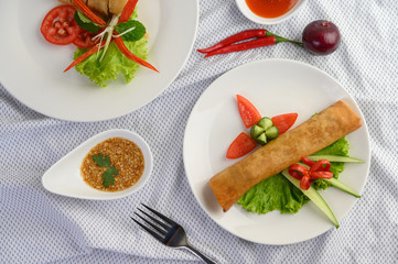 Egg roll or Fried Spring Rolls on the white plate Thai food. Top view.