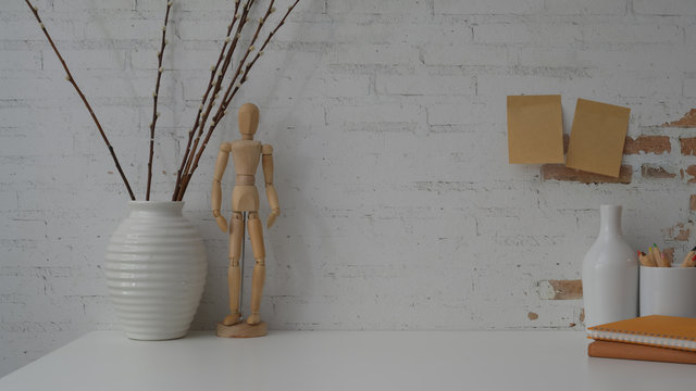 Close Up View Of Contemporary Workspace On White Table With White Brick Wall