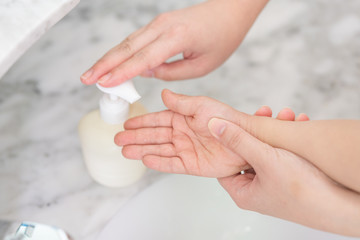 Young asian woman washing hands for her son