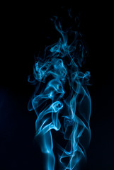 Beautiful smoke on the black background - macro photo. The concept of incense in the apartment....
