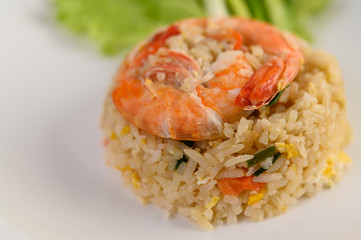 Shrimp fried rice on a white plate on a wooden table