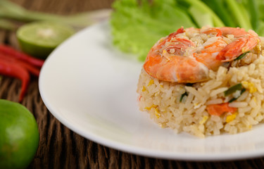 Shrimp fried rice on a white plate on a wooden table