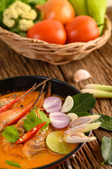 Tom Yum Kung Thai hot spicy soup shrimp with lemon grass,lemon,galangal and chilli on wooden background Thailand Food
